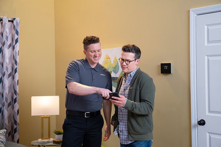 tempstar-dealer-showing-man-smart-thermostat